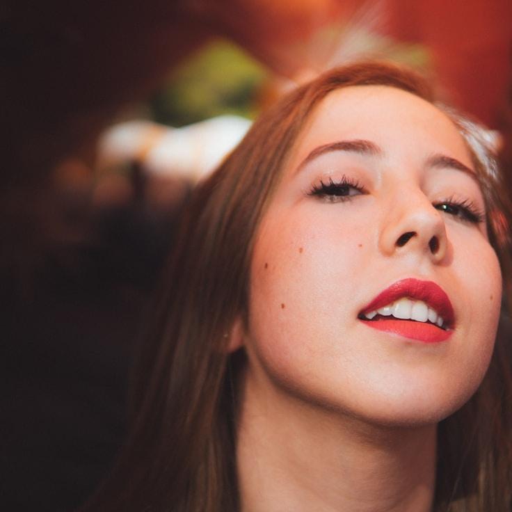 Alex Morgan, Lead Design Curator at FlorenDakosim, reviewing corporate floral arrangements